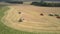 Aerial view green harvesters gather wheat near trucks