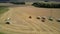 Aerial view green harvesters gather wheat throwing straw