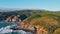 Aerial view green hills landscape stormy sea crashing rocky shoreline summer