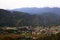 Aerial view of green hills of village in himachal surrounded by forest and countryside.