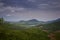 Aerial View Green Hilly Valley with Lake under Blue Sky