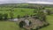 Aerial view green Ireland hinterland landscape. Drone point of view of green trees, meadow and cemetery in Ireland. No