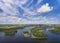 Aerial view of green islands and clouds at summer sunny day.Wydminy lake on Masuria in Poland.