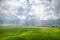 Aerial View of Green Lingko Spider Web Rice Fields with Sunlight Piercing Through Clouds to the Field with Raining. Flores, East N