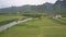 Aerial view green peanut fields near buildings and river