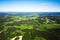 Aerial view of a green rural area under blue sky