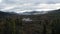 Aerial view of green spruce forest and cold clean river with rocks and cloudy sky on the background. Clip. National