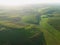 aerial view of green summer forest with green fields at Majestic sunrise, meadows.