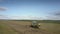 Aerial view green white harvester drives gathering wheat