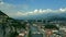 Aerial view of Grenoble cityscape, the Isere River and distant Belledonne, a French Alps mountain range in summer