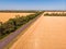 Aerial view of a grey asphalted narrow country road