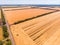 Aerial view of a grey asphalted narrow country road