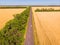 Aerial view of a grey asphalted narrow country road