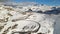 Aerial view of Grossgloknershtrasse in snow. Great high mountain road near Grossglokner mount in Austrian Alps.