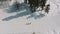 Aerial view of a group of athletes skiers stands talking on the ski slope of a ski resort in winter surrounded by forest