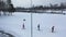 Aerial view of group of athletes taking part in a ski competition and running on a ski track. Footage. Sports and