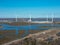 Aerial view of a group of four wind turbines on a marshy area