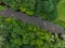 Aerial view of a group of kayaks traveling on a forest river on a summer day