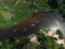 Aerial view of a group of kayaks traveling on a forest river on a summer day