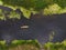 Aerial view of a group of kayaks traveling on a forest river on a summer day