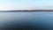 An aerial view of a group of mallard ducks swimming peacefully in a large lake. Wild ducks in vivo free nature