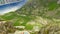 Aerial view of a group of tourists lying on the edge of a high cliff. Troll language. Norway. Extreme tourism