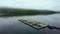 Aerial view of a half-constructed pier in the water of a lake in a rural area on a cloudy day