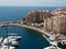 Aerial view of the harbor of Fontvieille with coastline buildings and parked boats, Monaco