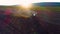 Aerial view of harvest fields with cultivating tractor. Farmer plowing stubble field