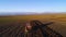 Aerial view of harvest fields with tractor. Farmer plowing stubble field