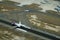 Aerial view of Hawaiian Plane landing on Runway