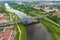 Aerial view on heavy traffic on a bridge with a wide multi-lane road across a wide river