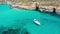 Aerial view from the height white yacht and panoramic view of the heavenly Blue Lagoon on the island of Comino Malta