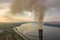 Aerial view of high chimney pipes with grey smoke from coal power plant. Production of electricity with fossil fuel