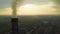 Aerial view of high chimney pipes with grey smoke from coal power plant. Production of electricity with fossil fuel.