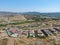 Aerial view of high class neighborhood with residential villas and swimming pools in dry valley