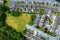 Aerial view on high density living area with houses built close to each other and park. Residential area in Ireland with private