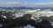 Aerial view. High over snowy village in the valley