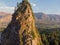 Aerial view of the high rock with green trees, mountain, forest and river background. Top view of beautiful landscape with highway