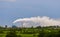 Aerial view of high smoke stack with smoke emission. Plant pipes pollute atmosphere. Industrial factory pollution, smokestack