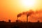 Aerial view of high smoke stack with smoke emission. Plant pipes pollute atmosphere. silhouette background