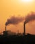 Aerial view of high smoke stack with smoke emission. Plant pipes pollute atmosphere. silhouette background