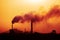 Aerial view of high smoke stack with smoke emission. Plant pipes pollute atmosphere. silhouette background