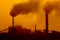 Aerial view of high smoke stack with smoke emission. Plant pipes pollute atmosphere. silhouette background