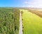 Aerial view of highway with car. Aerial view of a country road with moving car. Car passing by. Aerial road. Aerial view flying. C