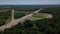 Aerial view of highway cloverleaf interchange seen from above.