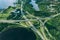 Aerial view of highway and overpass road with green woods and blue lakes in Finland