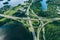 Aerial view of highway and overpass road with green woods and blue lakes in Finland