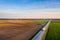 Aerial view of a highway passing through spring agricultural fields