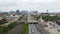 Aerial view of a highway road with traffic with a modern city on the background